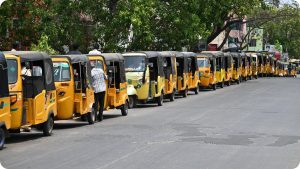Long line of auto-rickshaws waiting at an LPG dispensing station in Chennai.