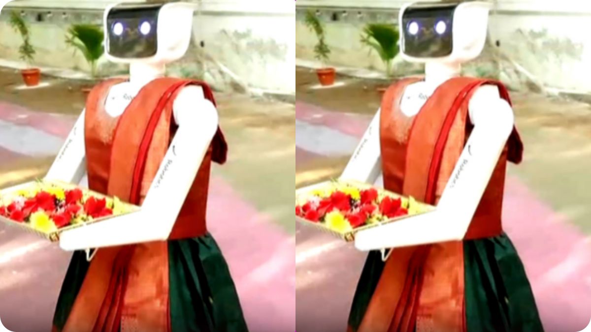 A friendly service robot named Tina offering chocolates to voters at a Tamil Nadu polling station.