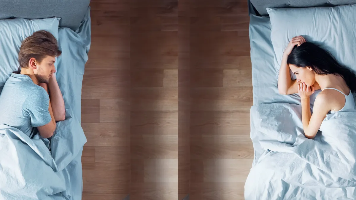 Two separate modern beds in a single stylish room representing the sleep divorce trend.