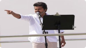 TVK Chief Vijay greeting a massive crowd during a roadshow in T.Nagar, Chennai, ahead of the 2026 polls.