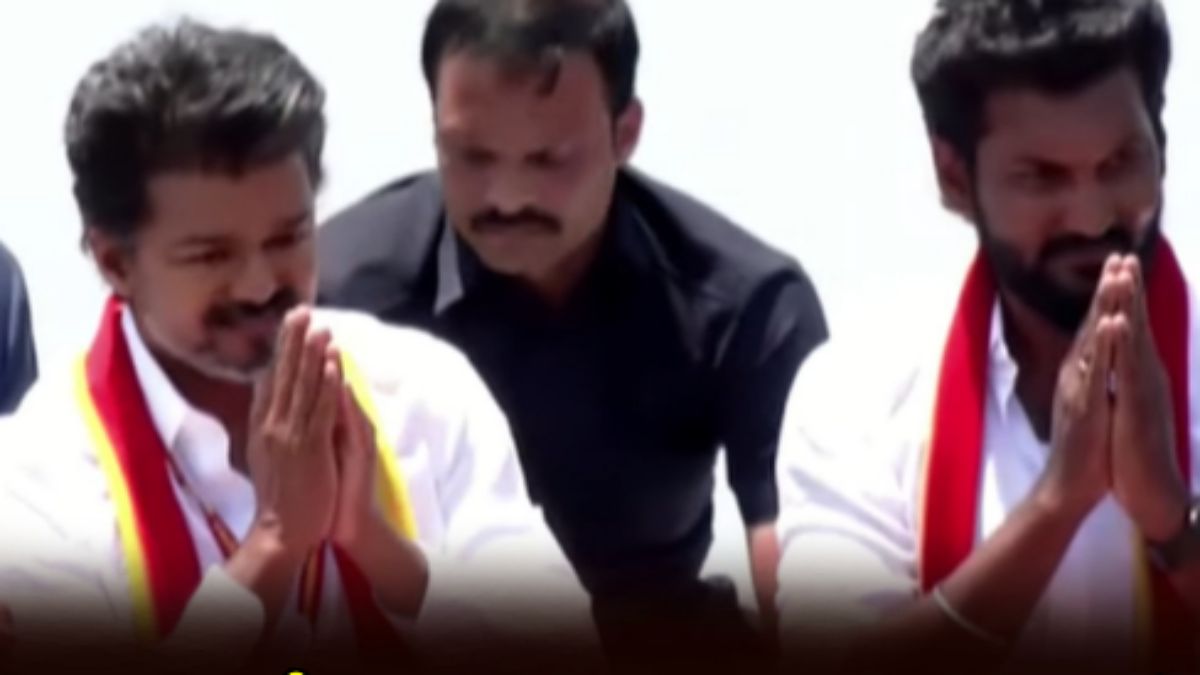 TVK President Vijay standing with candidate Sarathkumar on a campaign vehicle at Tambaram toll plaza in April 2026.