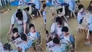 A sweet little young school girl helping her adult pregnant teacher inside a colorful kindergarten classroom layout.