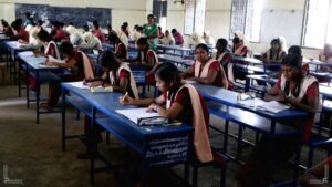 Organized classroom desk setups inside a regional school examination center with proper spaces arranged for board exams.