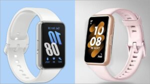 A sleek modern rectangular smart fitness band with a vibrant AMOLED display showing heart rate tracking graphics placed on a tech workspace backdrop.