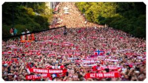 Thousands of Norwegian football fans waving national flags outside the Royal Palace to welcome their team.